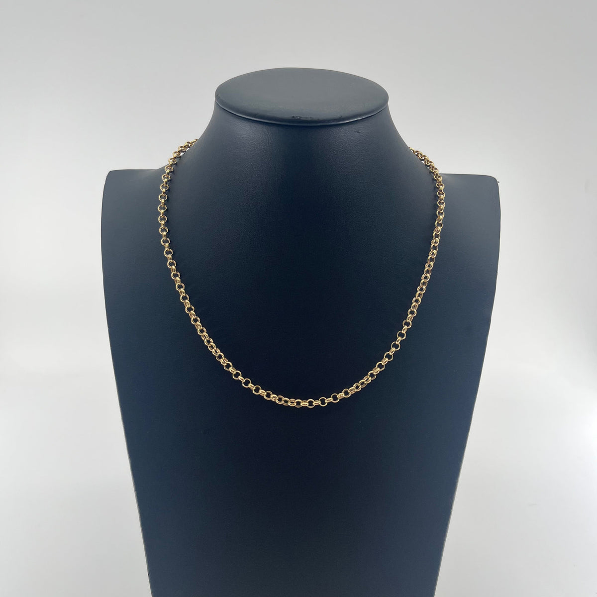 CB Stores yellow gold chain necklace with small round links, displayed on a black bust against a white background.