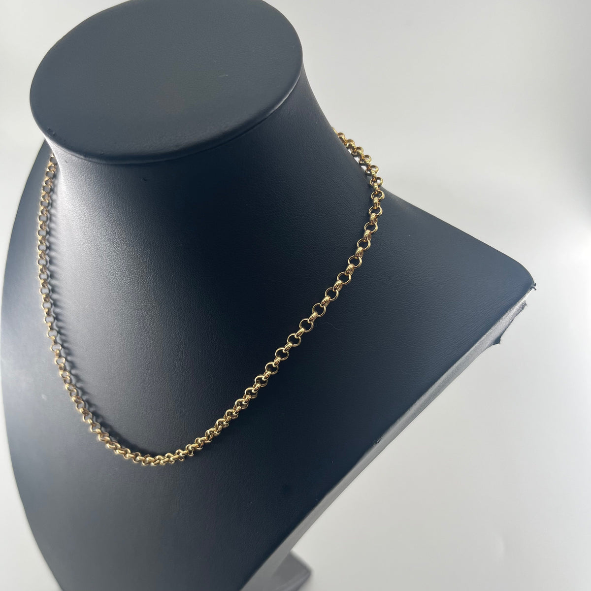 CB STORES yellow gold belcher chain necklace with round links displayed on a black stand against a white background.