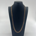 CB STORES yellow gold flat curb chain displayed on a black bust with a white background.