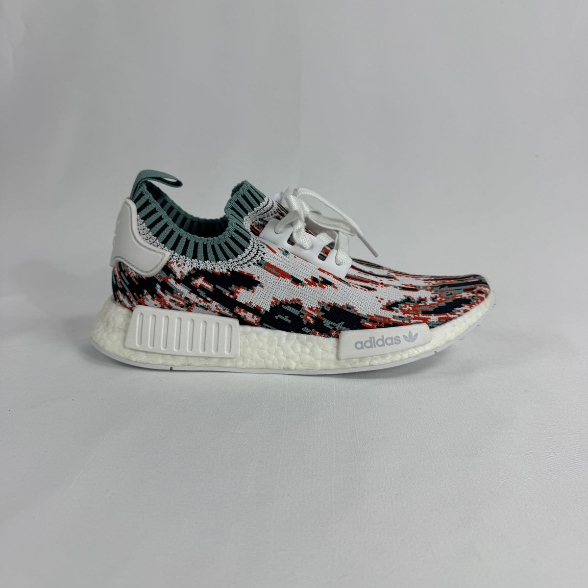 The Adidas NMD R1 Datamosh Collegiate is a lifestyle sneaker featuring a breathable knit upper with digitally inspired