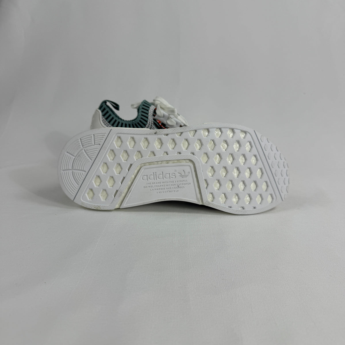 The Adidas NMD R1 Datamosh Collegiate is a lifestyle sneaker featuring a breathable knit upper with digitally inspired