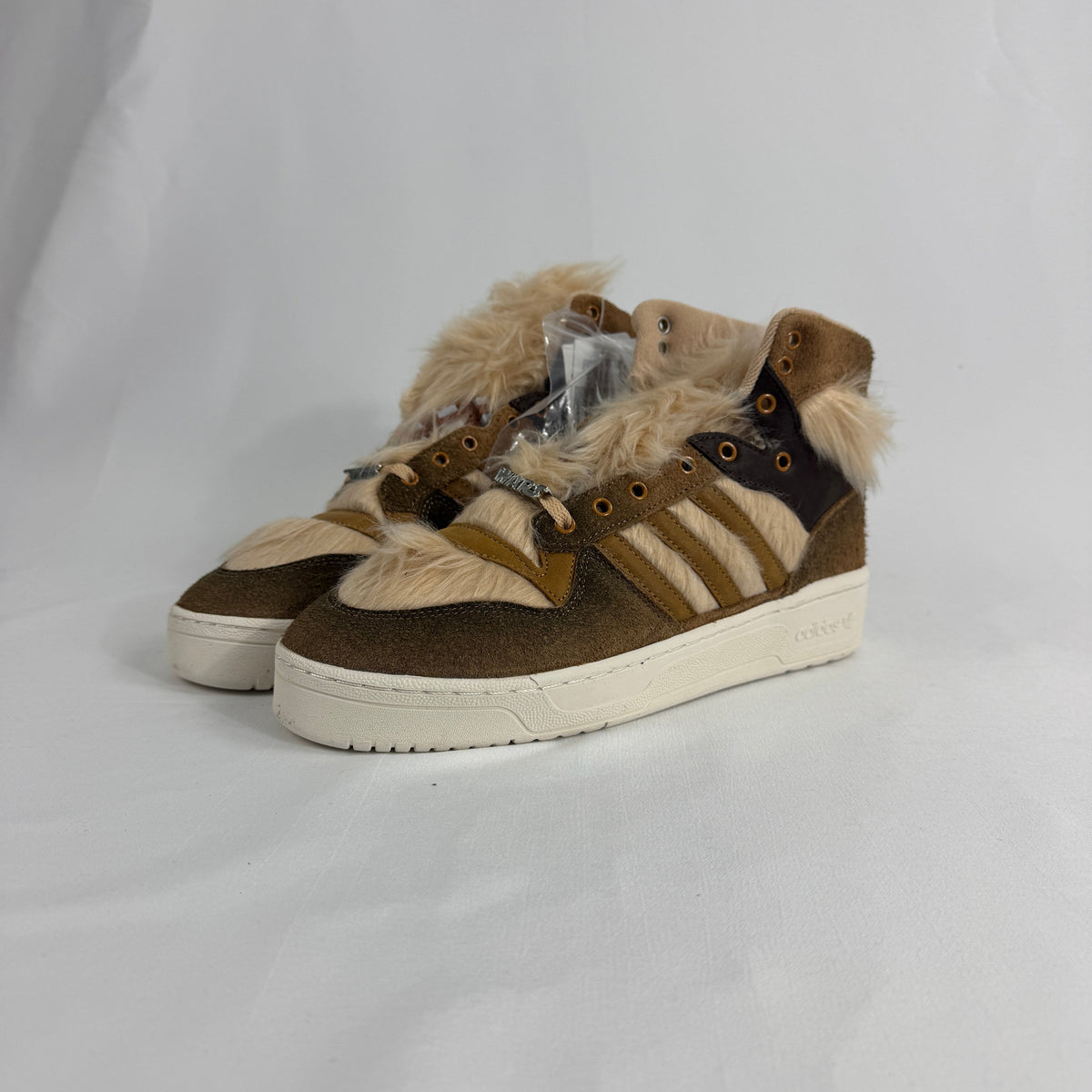 The Adidas Rivalry Hi Star Wars Chewbacca is a high-top sneaker inspired by the iconic Star Wars character, featuring