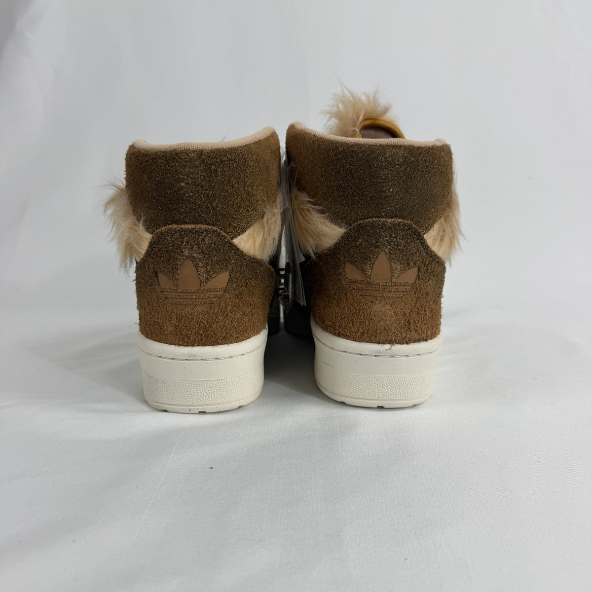The Adidas Rivalry Hi Star Wars Chewbacca is a high-top sneaker inspired by the iconic Star Wars character, featuring