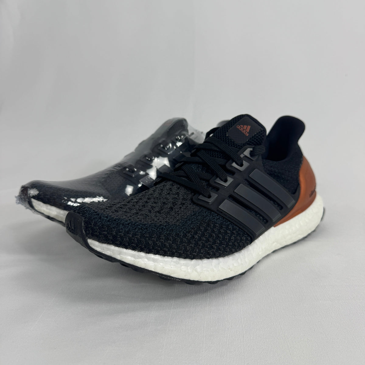 The Adidas Ultra Boost Bronze is a performance-inspired sneaker featuring a breathable Primeknit upper, responsive Boost
