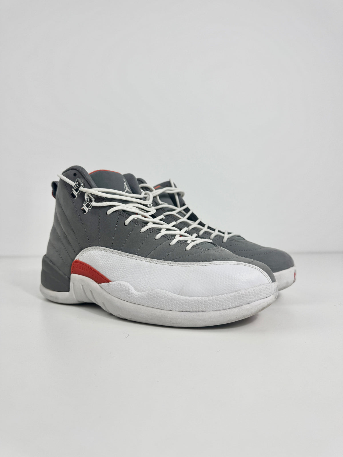 Air Jordan 12 Retro Grey combines a premium grey leather upper with iconic lizard-textured mudguards for a sleek,