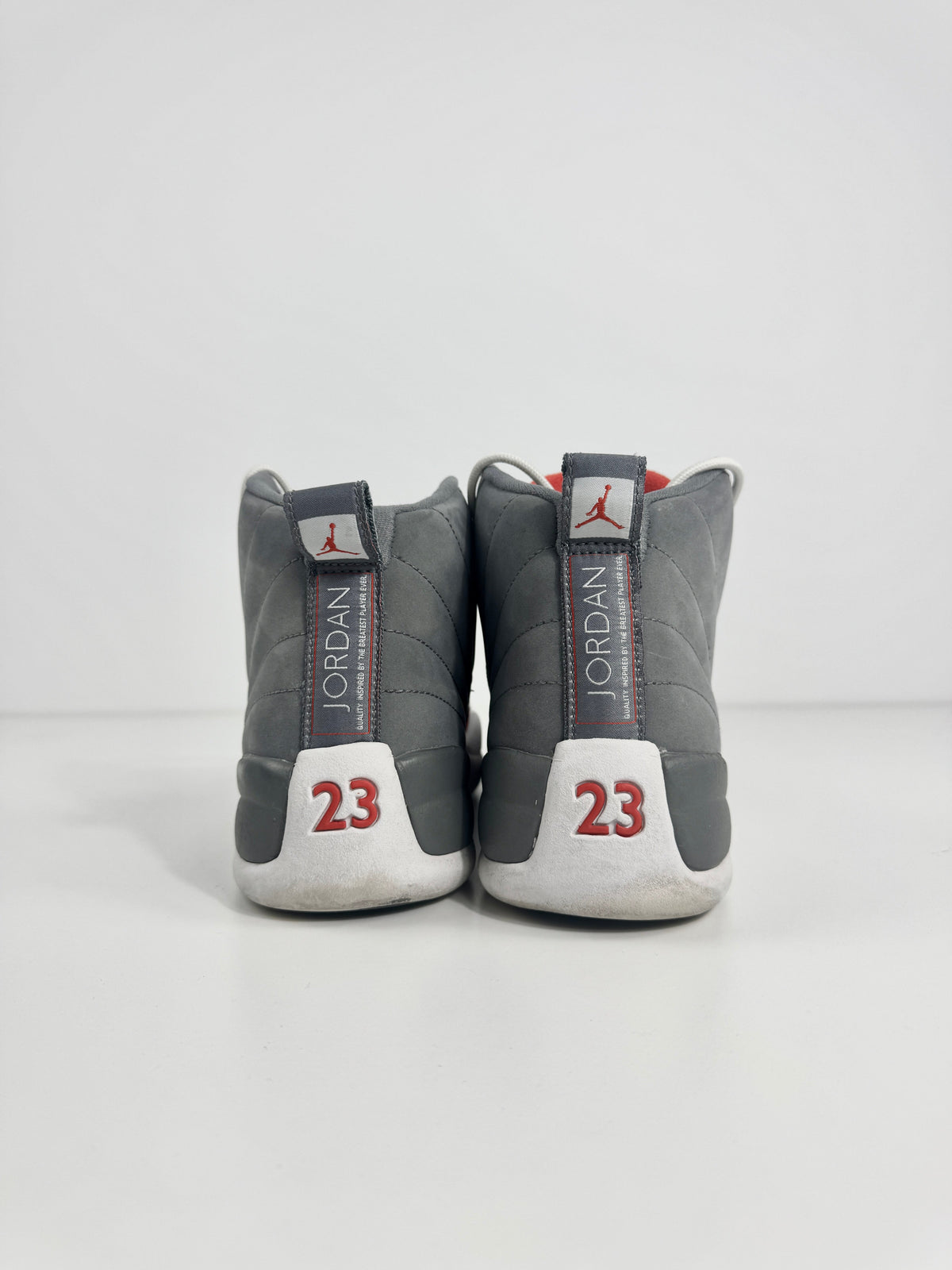Air Jordan 12 Retro Grey combines a premium grey leather upper with iconic lizard-textured mudguards for a sleek,