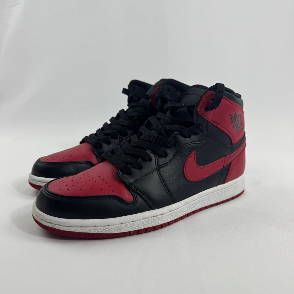 NIKE Air Jordan 1 trainers in black and red leather with white midsoles and black laces, shown on a plain white background.
