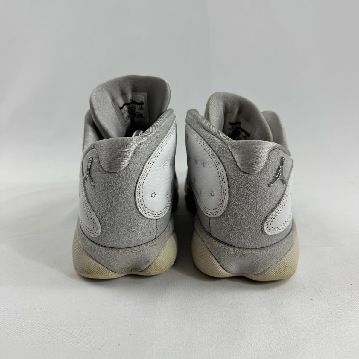 Air Jordan 1 Retro Low “Pure Platinum” is a clean low-top sneaker in mostly white leather with light grey detailing, giving
