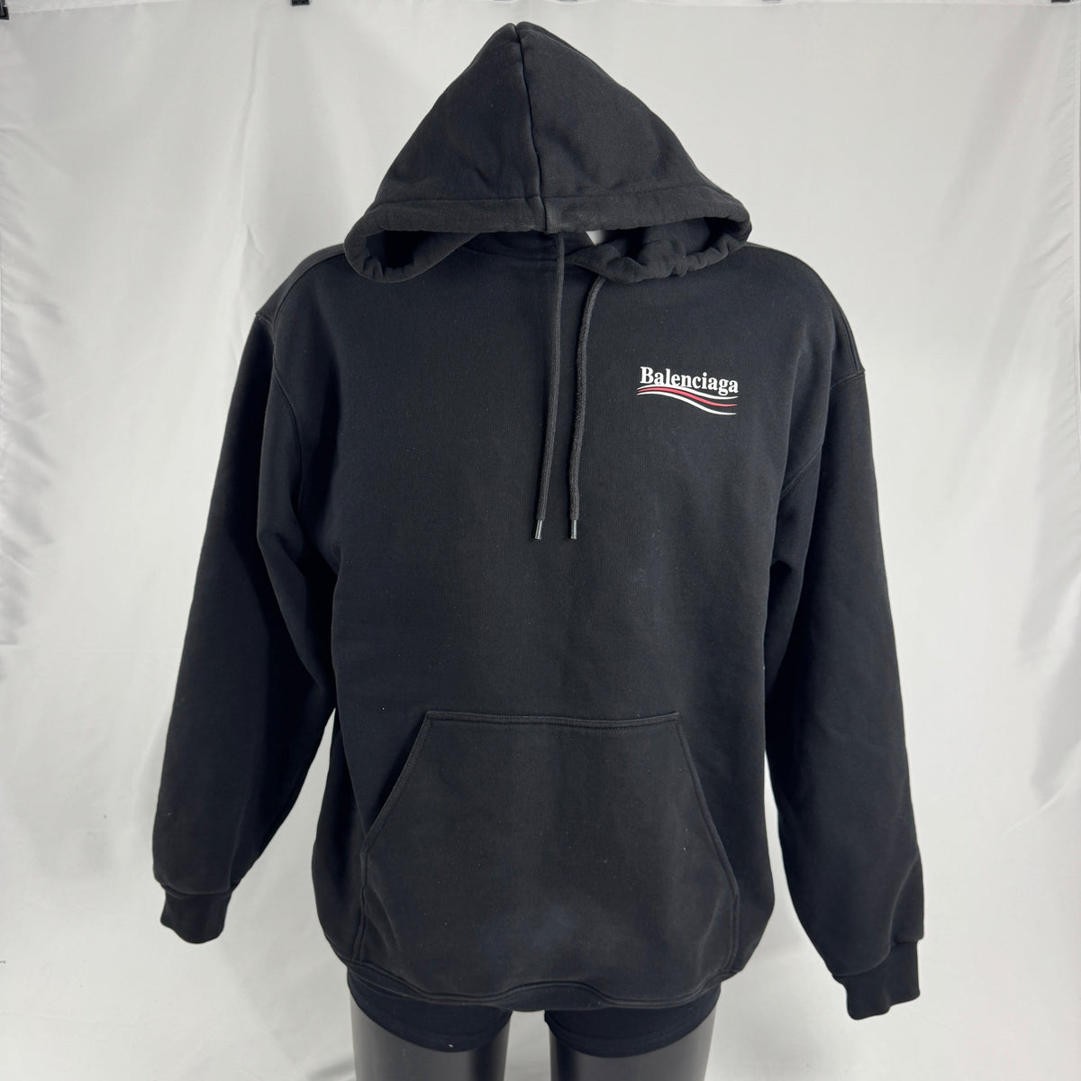 The Balenciaga Political Campaign Hoodie is a heavyweight cotton hoodie featuring the brand’s satirical “campaign” logo