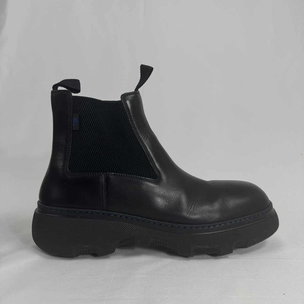 The Burberry Creeper Chelsea Low is a modern take on the classic Chelsea boot, blending sleek British tailoring with a