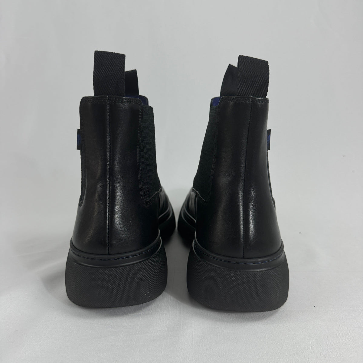 The Burberry Creeper Chelsea Low is a modern take on the classic Chelsea boot, blending sleek British tailoring with a