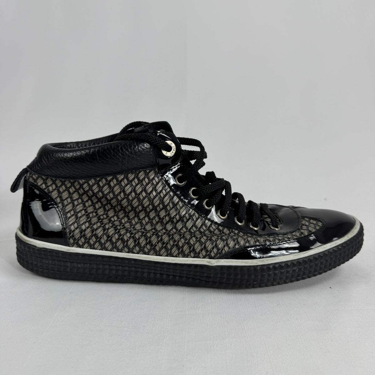 The Jimmy Choo Belgravia High-Top is a luxury sneaker that combines contemporary streetwear style with premium