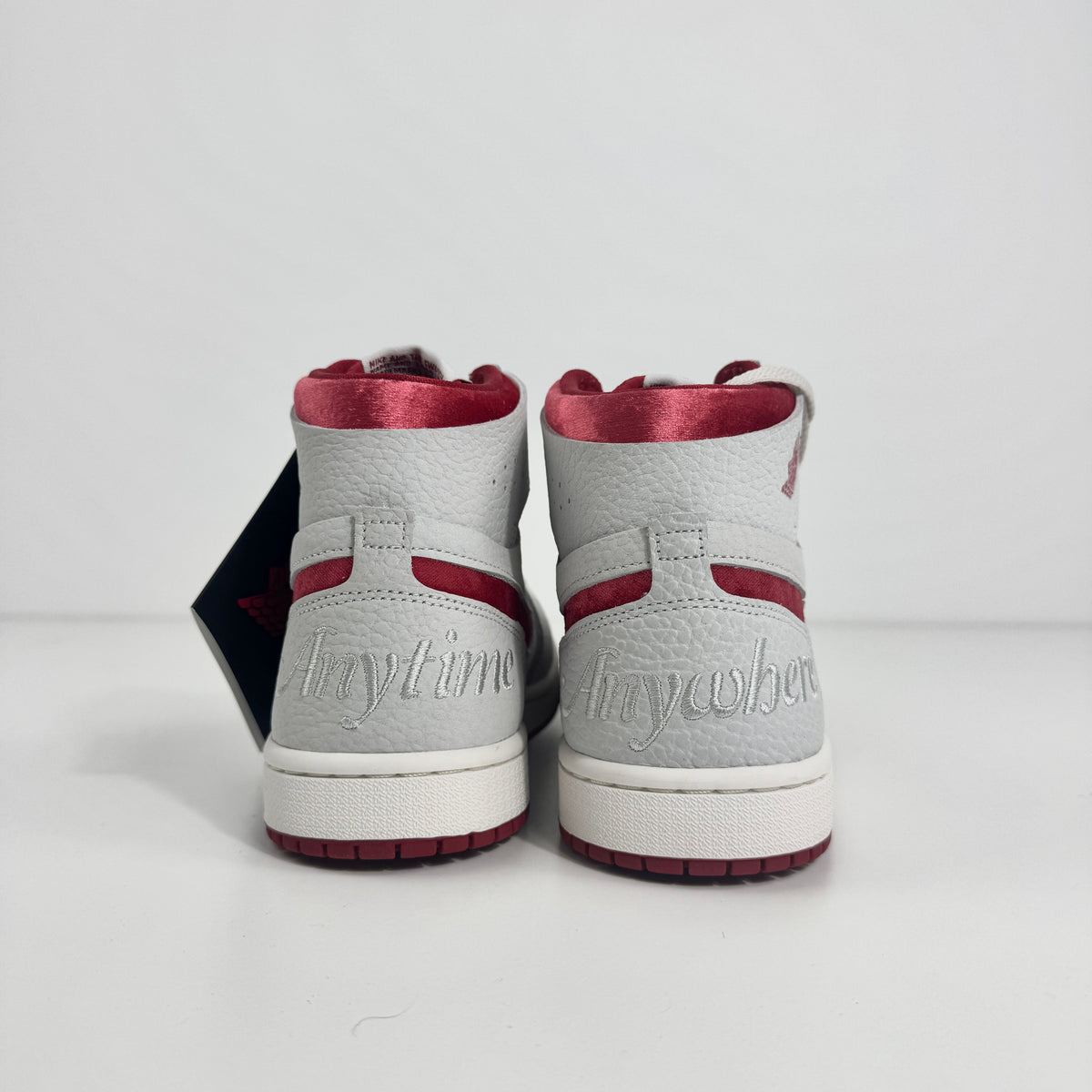 Jordan 1 Mid Zoom Grey/Red is a stylish mid-top sneaker featuring a grey upper with bold red accents for a striking look. It