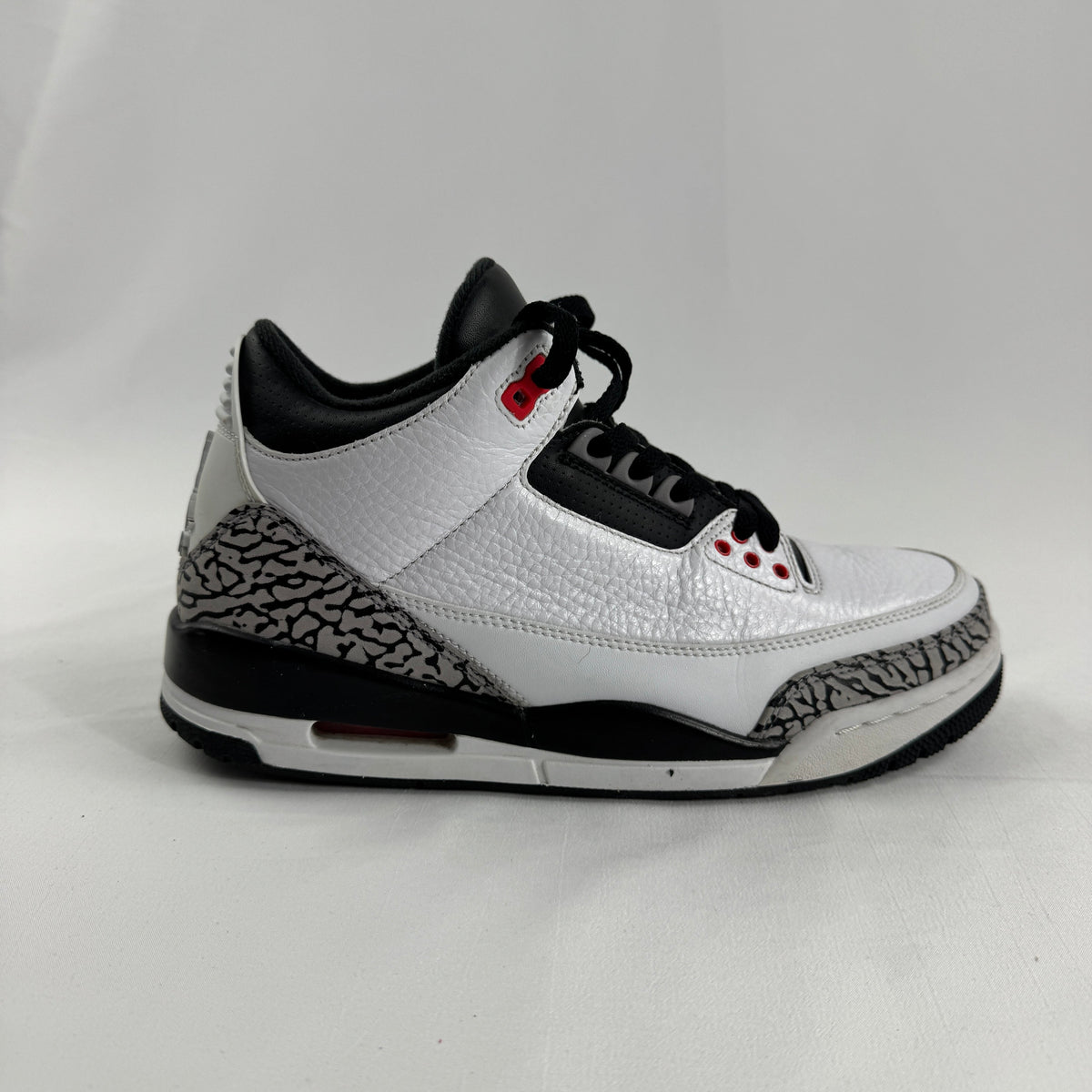 The Air Jordan 3 Retro “Pure Money/Infrared” is a mostly white leather Jordan 3 with silver accents and subtle infrared red