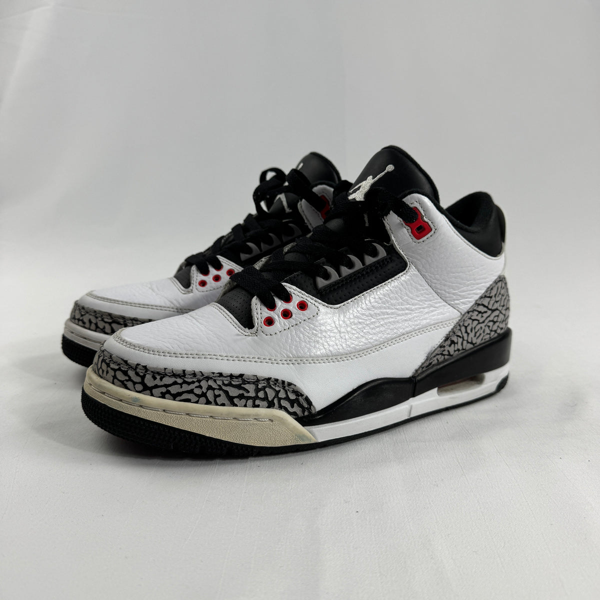 The Air Jordan 3 Retro “Pure Money/Infrared” is a mostly white leather Jordan 3 with silver accents and subtle infrared red