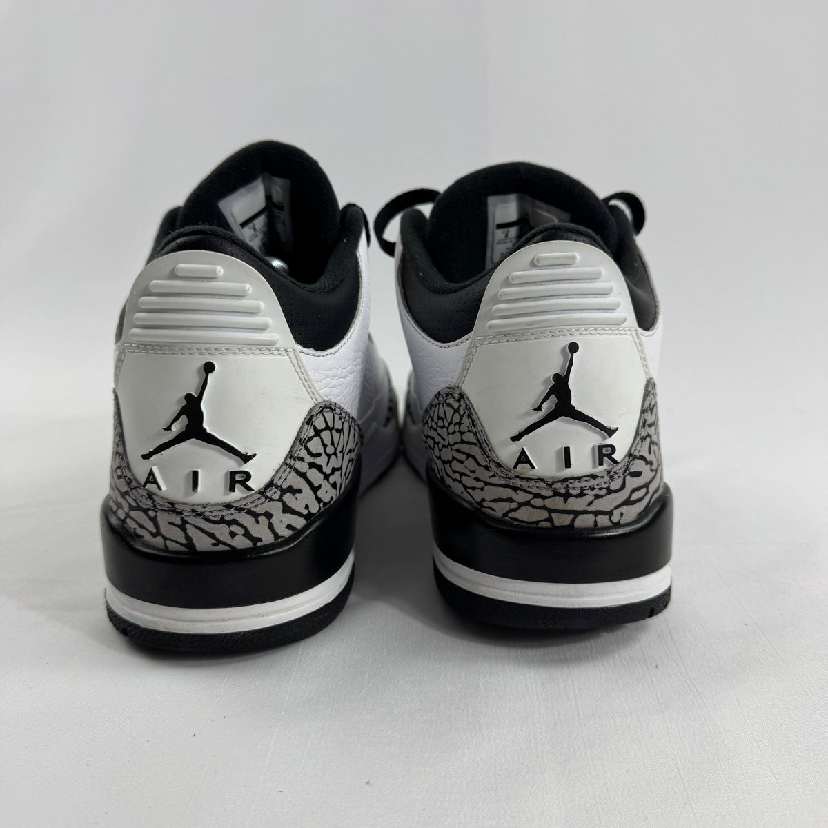 The Air Jordan 3 Retro “Pure Money/Infrared” is a mostly white leather Jordan 3 with silver accents and subtle infrared red