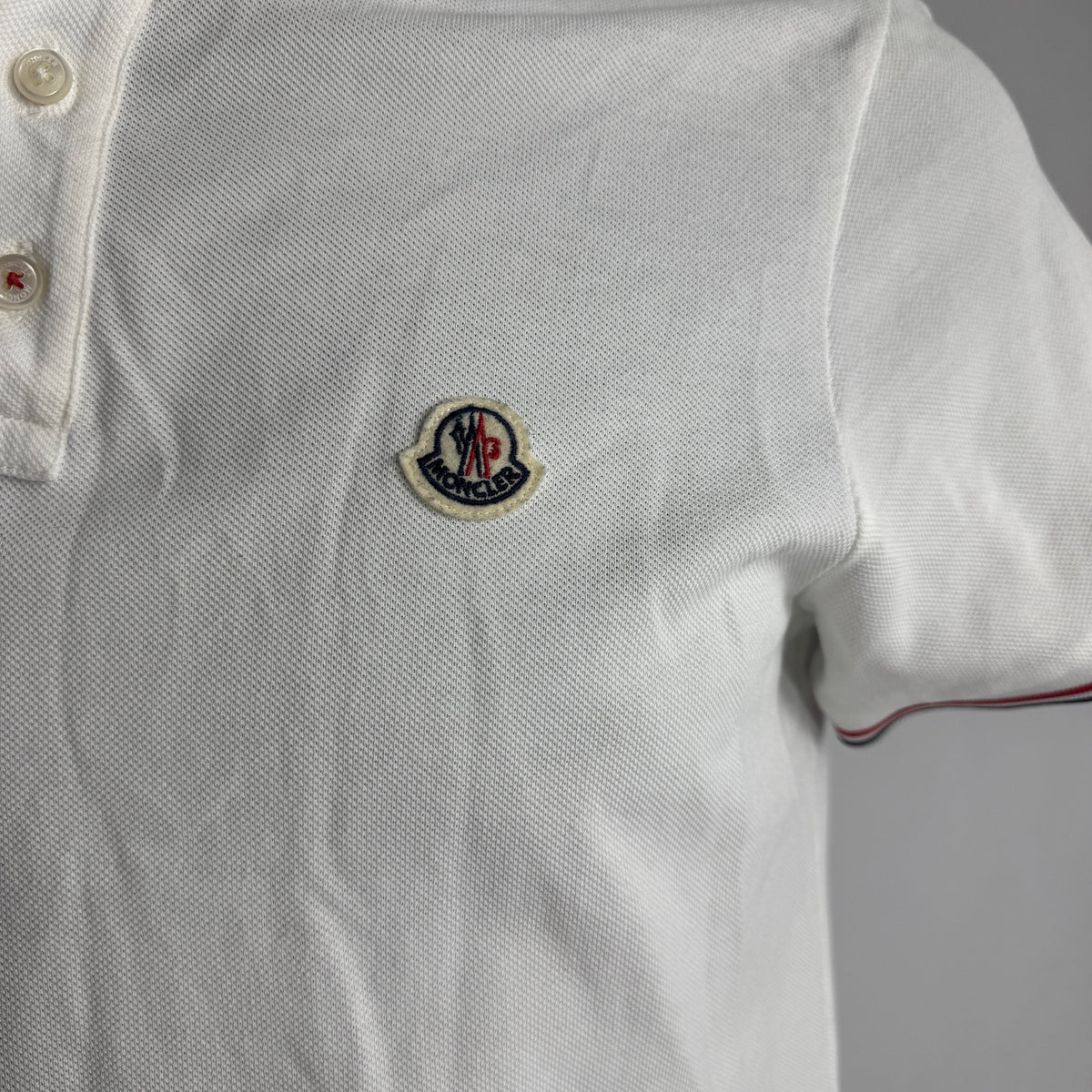 Moncler Polo Shirt crafted from premium cotton piqué, featuring a classic collar, button placket, signature logo patch, and