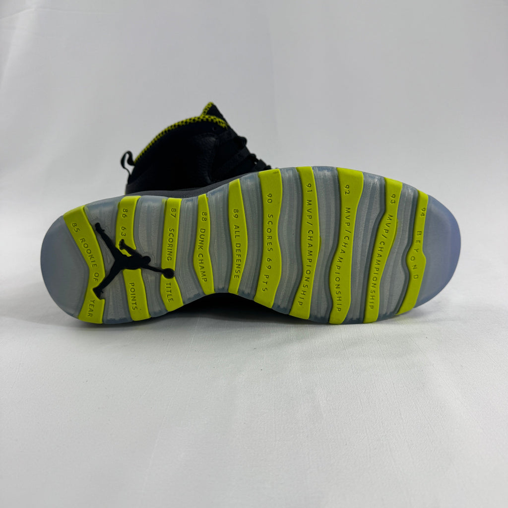 The Nike Air Jordan 10 Retro Black Venom features a sleek black tumbled leather upper paired with vibrant Venom Green