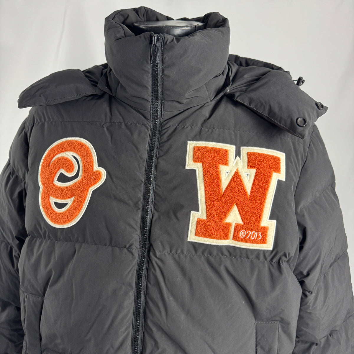 The Off-White Patch Puffer Jacket is a padded winter jacket featuring premium insulation, a relaxed fit, and signature