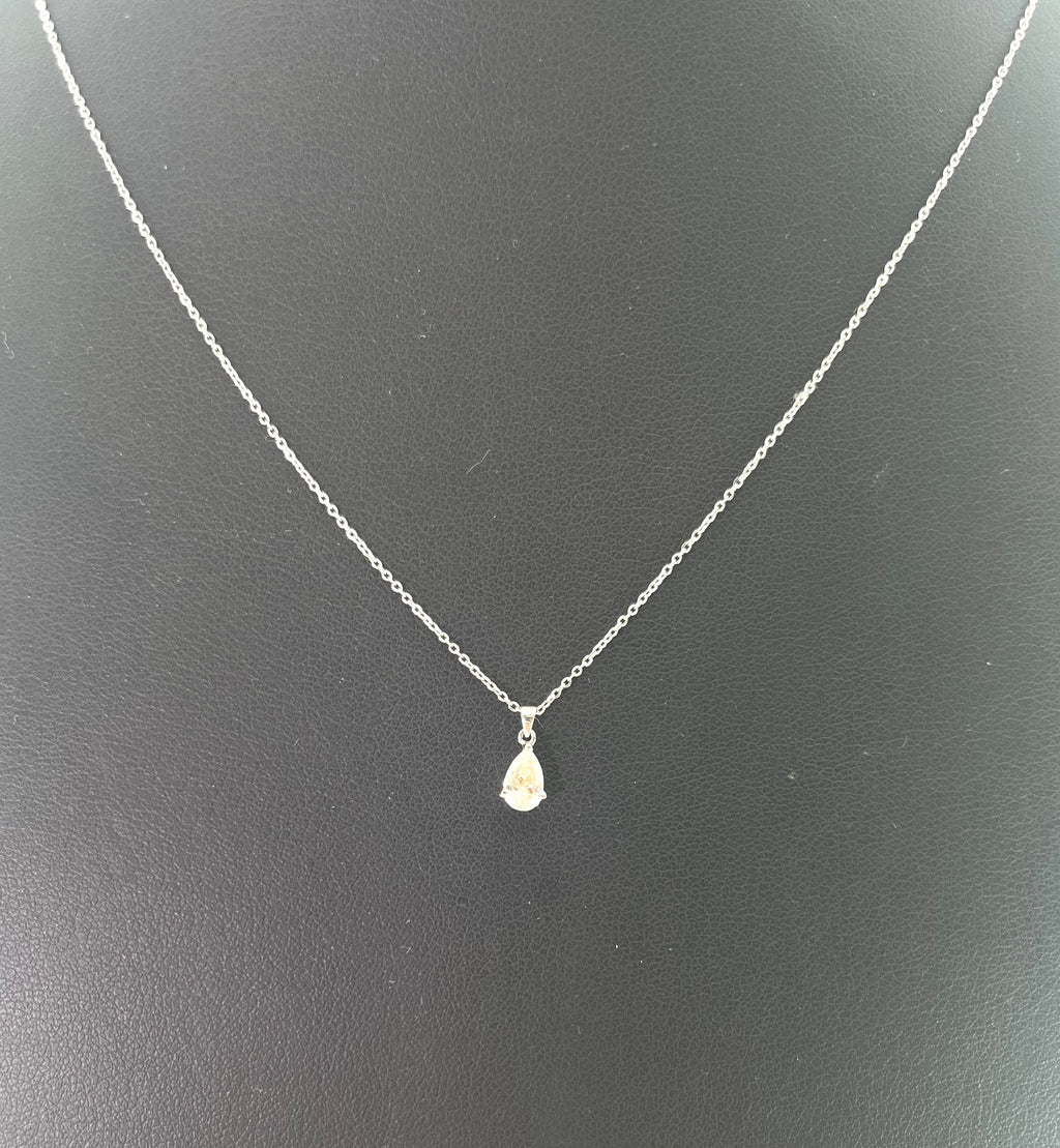 CB STORES pear-shaped diamond necklace in platinum shown against a plain black background.