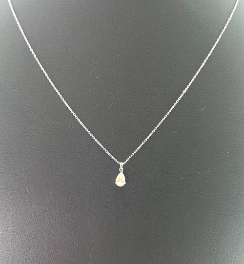 CB STORES pear-shaped diamond necklace in platinum shown against a plain black background.